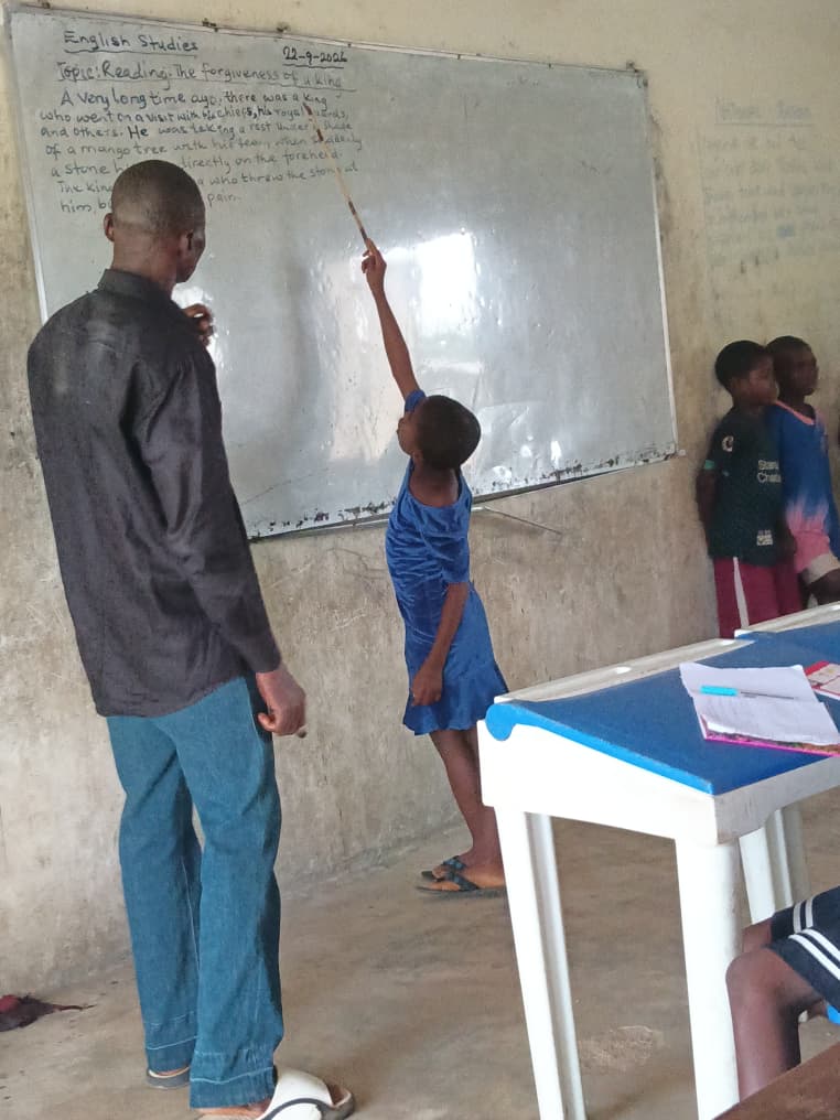 A teacher and a student at the board during an English lesson