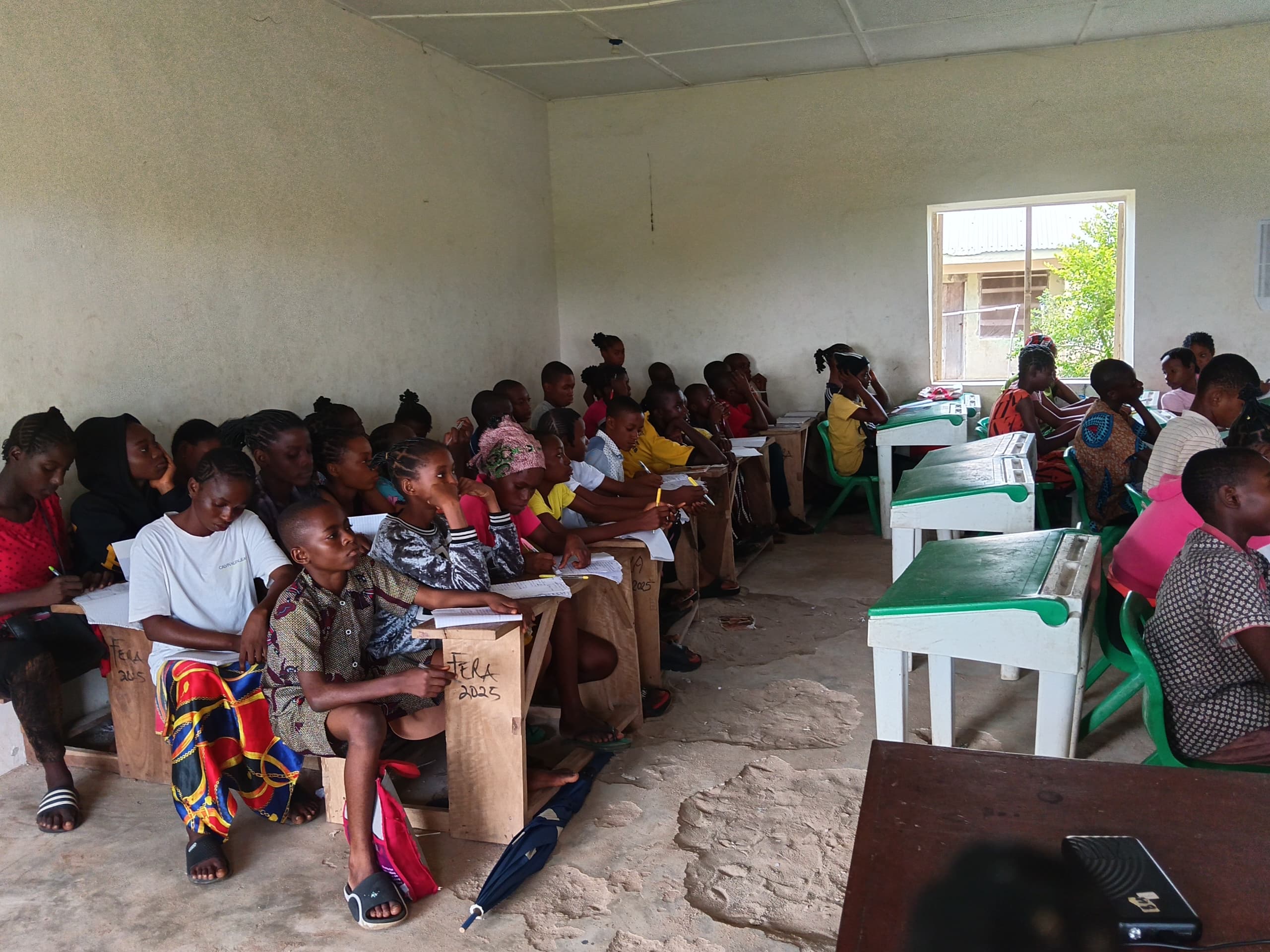 Students writing at their desks in a classroom